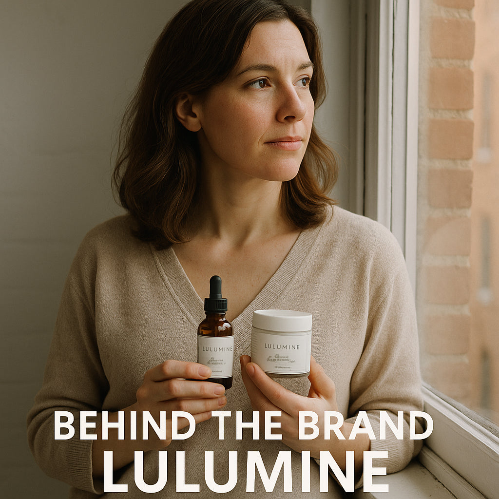 Founder reflecting by a window with natural light, holding Lulumine products. Alt: behind the brand Lulumine founder story with founder holding organic skincare products.