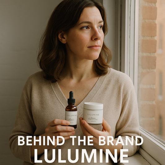 Founder reflecting by a window with natural light, holding Lulumine products. Alt: behind the brand Lulumine founder story with founder holding organic skincare products.